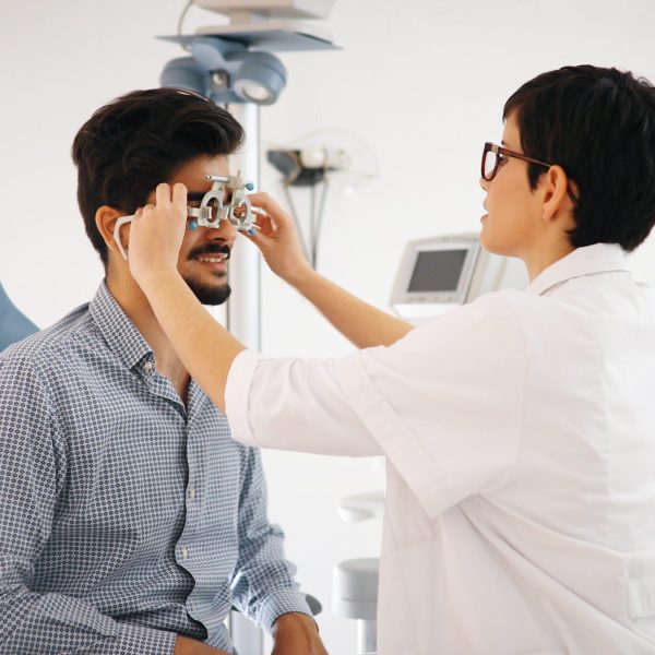 Woman doing eye test with optometrist in medical office